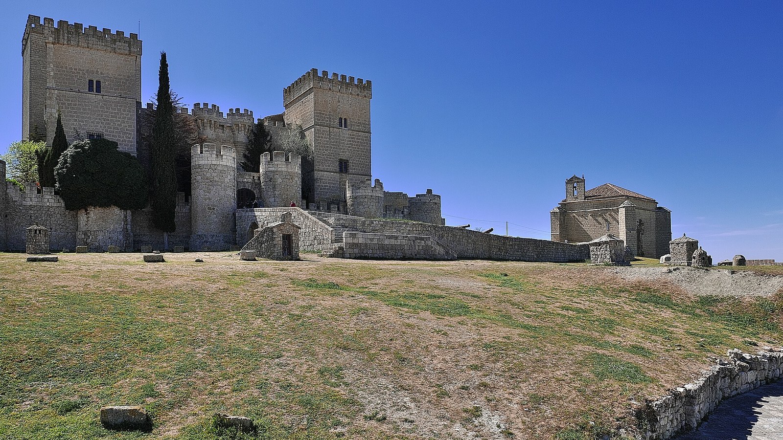 El castillo de Ampudia con sus torres y, al lado, la ermita de Santiago