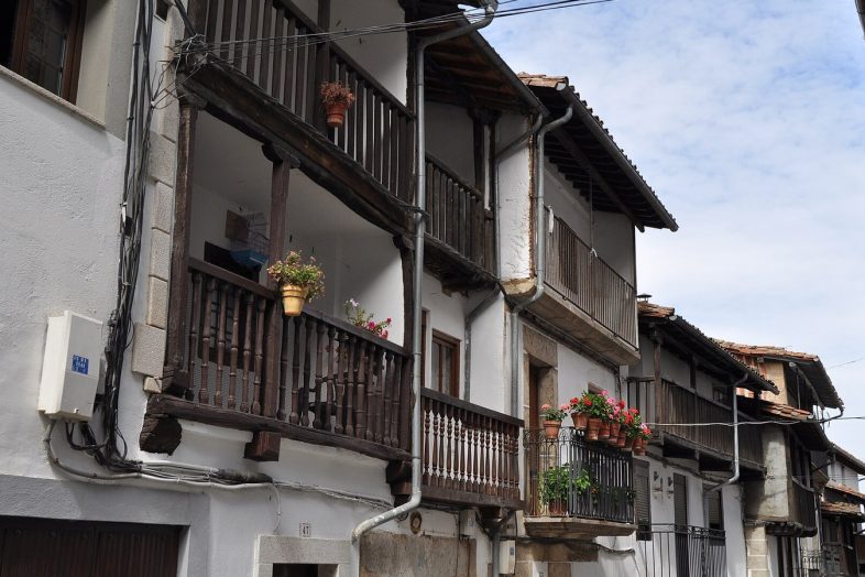 Calle de Candelario con las casas de balcones corridos de madera y macetas de geranios