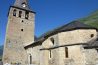 La iglesia de San Julian de Garos con su campanario ancho y la montana detras
