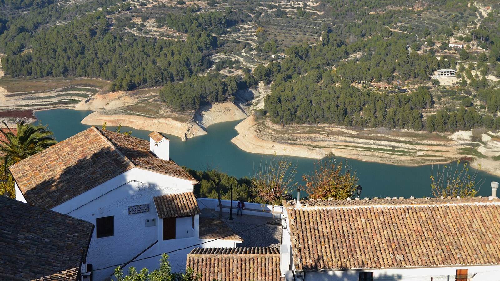 Casas de Guadalest con el embalse de agua turquesa al fondo, entre montañas